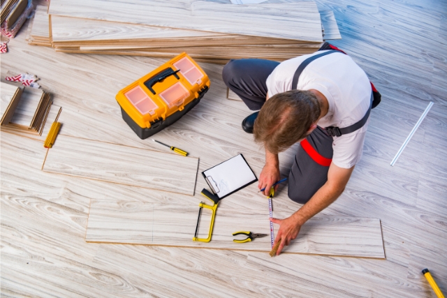 Worker Laying Laminate Flooring